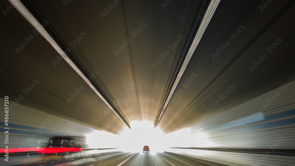 This is a long exposure motion blur image of the light trail going out of the tunnel. This is a long exposure motion blur image of the light trail going out of the tunnel.