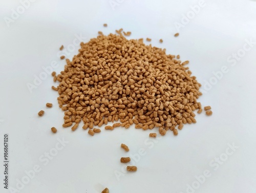 a pile of bright brown turtle pellets on a white background.