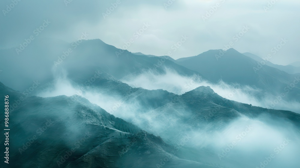 A mysterious mountain range shrouded in fog and mist, creating a dramatic and atmospheric scene. A mysterious mountain range shrouded in fog and mist, creating a dramatic and atmospheric scene.