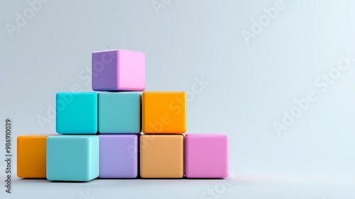 Colorful cubes stack neatly on a soft grey background, showcasing minimalist design.