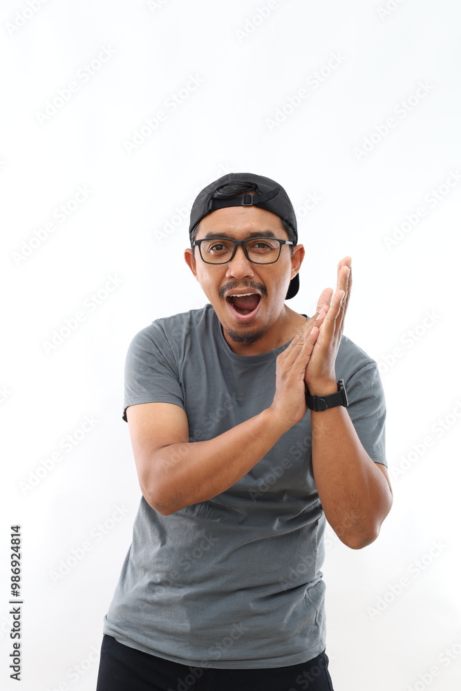 Naklejka premium Young handsome asian man with beard wearing casual shirt and glasses over white background clapping and applauding happy and joyful, smiling proud hands together