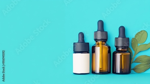 Three glass dropper bottles filled with essential oils are neatly lined up on a vibrant blue background alongside fresh green leaves, showcasing a natural wellness aesthetic