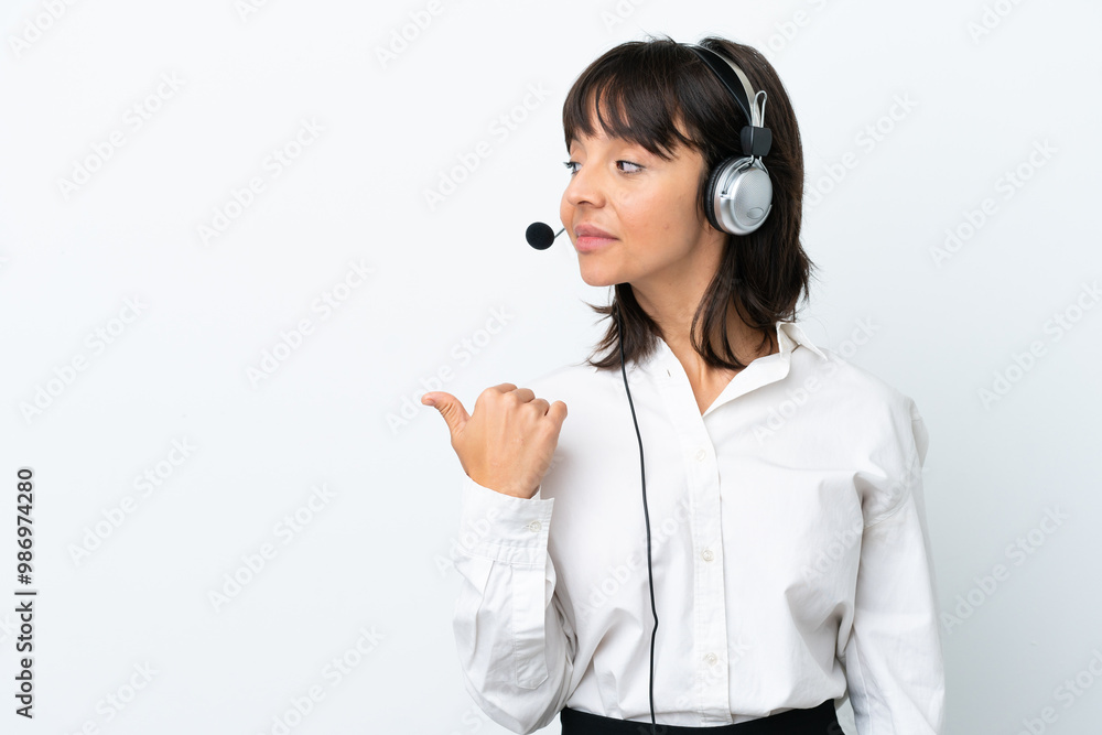 Telemarketer mixed race woman working with a headset isolated on white background pointing to the side to present a product Telemarketer mixed race woman working with a headset isolated on white background pointing to the side to present a product