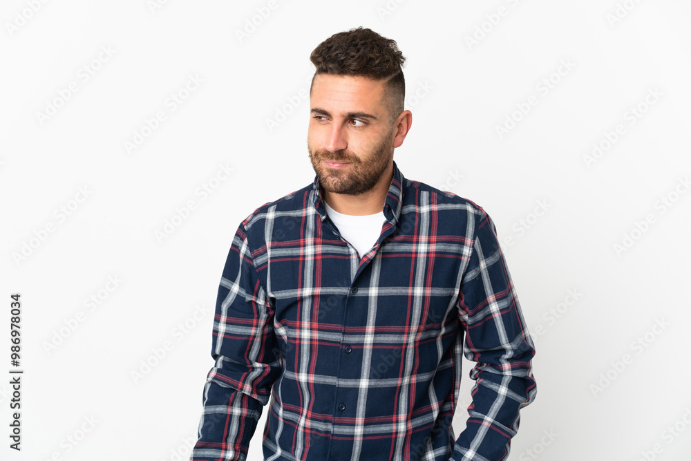 Caucasian man isolated on white background having doubts while looking side Caucasian man isolated on white background having doubts while looking side
