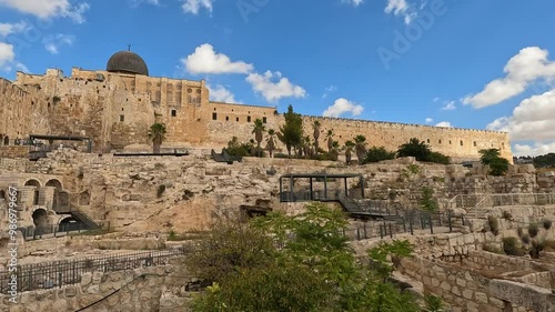 Ancient archaeological garden of a biblical city next to the Temple Mount in the Old City of Jerusalem - israel, with the Dome of the Rock in the background.