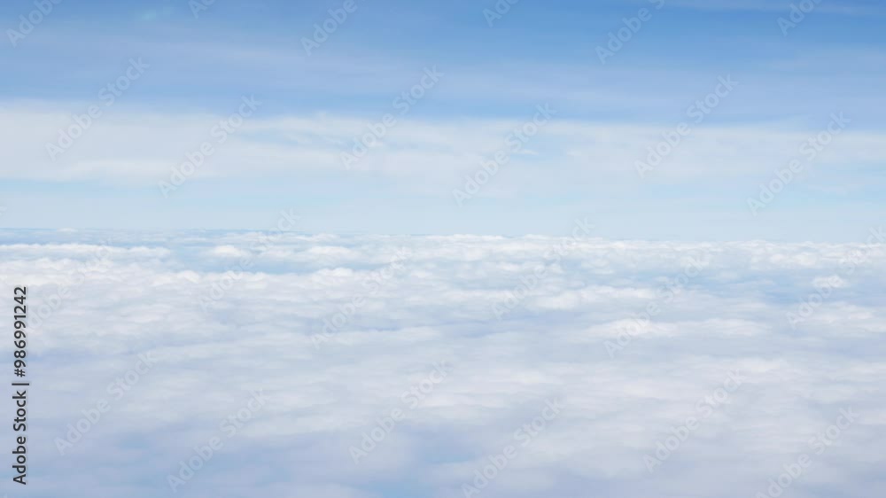 Aerial view above the clouds and sky inspiration concept in cinematic breathtaking aerial flying over white fluffy cloudscape in high altitude sky with fresh clean air and blue skies on background. Aerial view above the clouds and sky inspiration concept in cinematic breathtaking aerial flying over white fluffy cloudscape in high altitude sky with fresh clean air and blue skies on background.