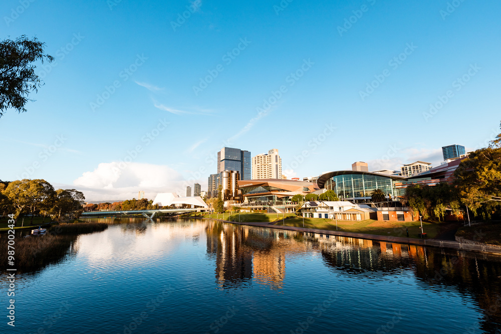 View of Adelaide city across the Torrens River with buildings reflected in water View of Adelaide city across the Torrens River with buildings reflected in water