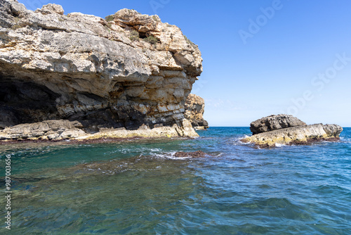 Obraz na płótnie View from the water of picturesque coastline with cliffs and caves by Adriatic Sea, Polignano a Mare, Italy, Apulia w salonie