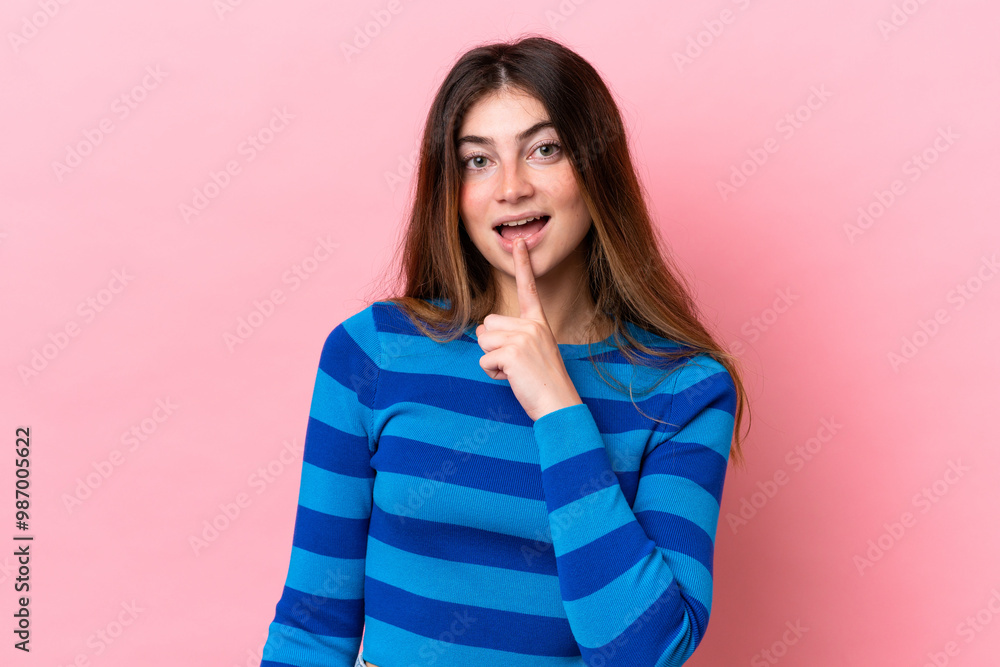 Young caucasian woman isolated on pink background showing a sign of silence gesture putting finger in mouth Young caucasian woman isolated on pink background showing a sign of silence gesture putting finger in mouth