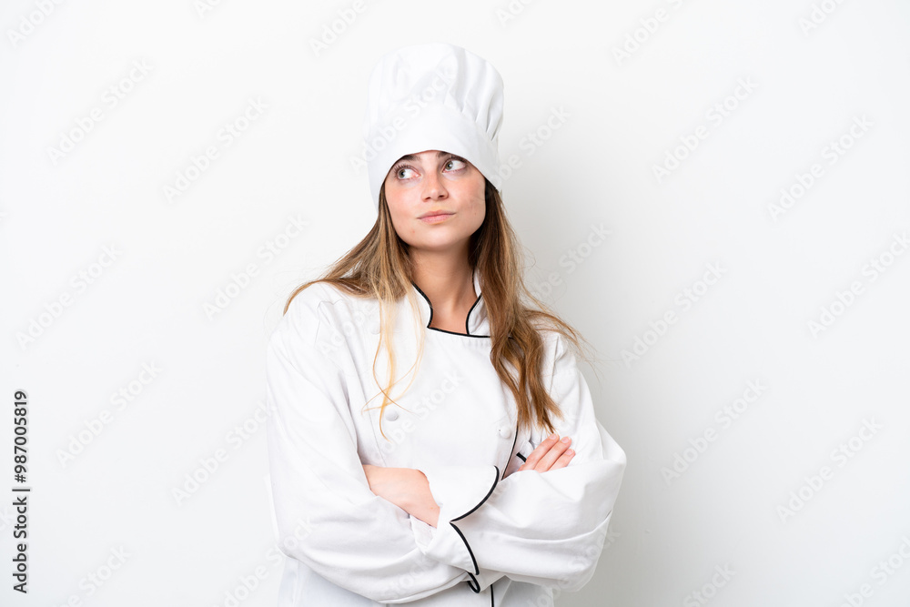 Young caucasian chef woman isolated on white background making doubts gesture while lifting the shoulders Young caucasian chef woman isolated on white background making doubts gesture while lifting the shoulders