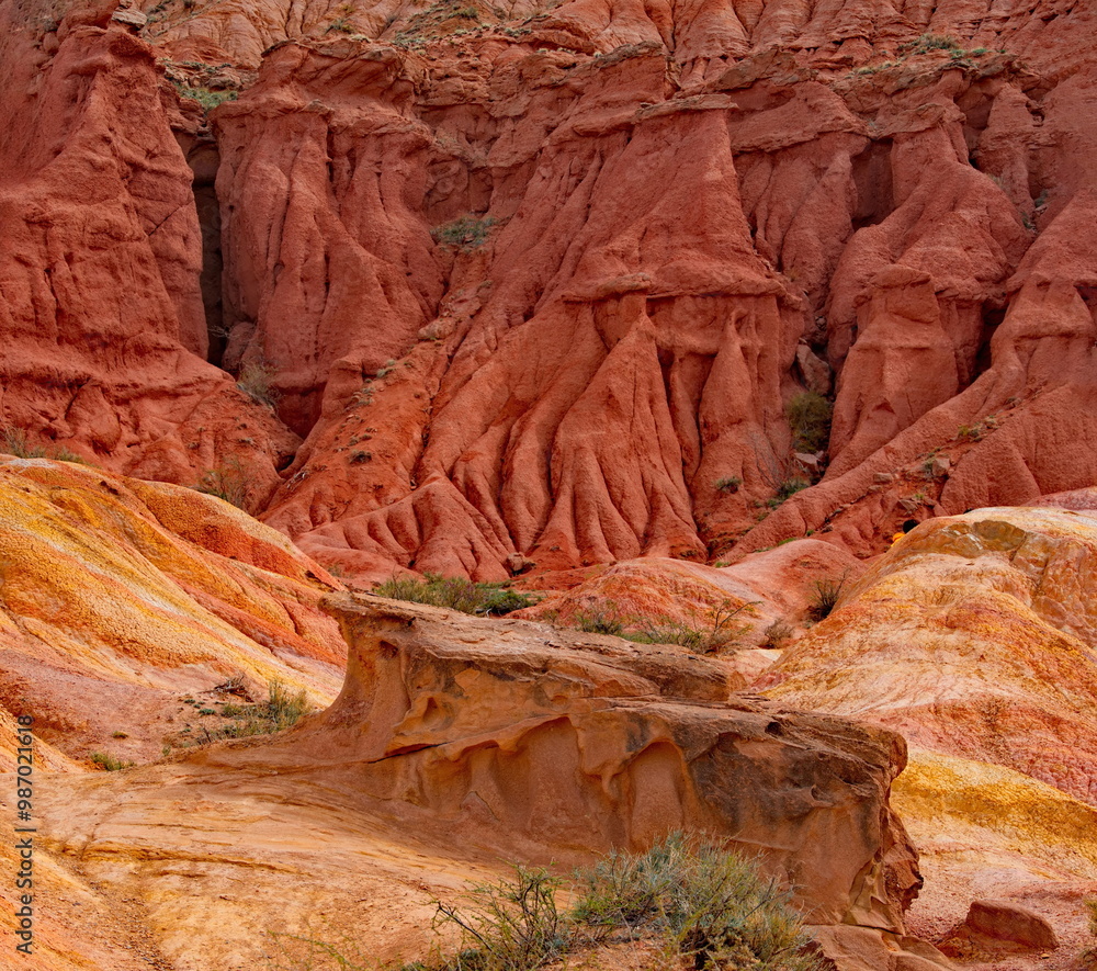 Northern Kyrgyzstan. The unusual texture of red-yellow clay rocks in the famous Skazka Canyon, off the coast of Lake Issyk-Kul. Northern Kyrgyzstan. The unusual texture of red-yellow clay rocks in the famous Skazka Canyon, off the coast of Lake Issyk-Kul.