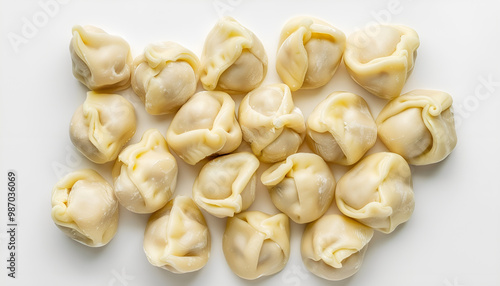 Many raw dumplings (varenyky) with potato on white background, top view