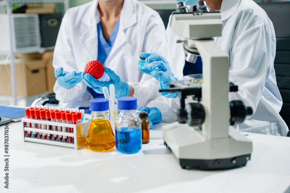 Fototapeta premium scientists in lab coats conducting research, handling glassware, and working with chemicals