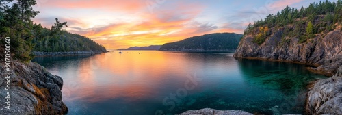  A tranquil body of water, bordered by trees and a rocky cliff face, undergoes a breathtaking transformation as the sun sets In the heart of this ser