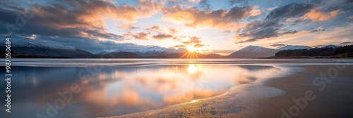  A body of water encircled by mountains, beneath a cloud-filled sky, where sunlight filters through and mirrors on its surface