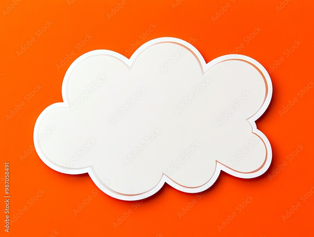 A white cloud shaped paper cut out on an orange background A white cloud shaped paper cut out on an orange background