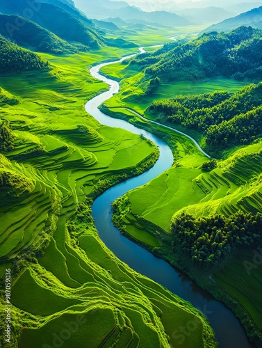 A river running through a lush green valley surrounded by mountains