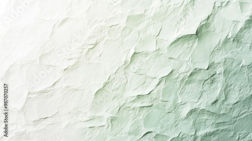 Pale mint green to white gradient with a rough, uneven texture, offering a light and refreshing background design. photo