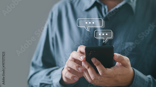 Fotografi A person interacts with a smartphone, sending messages with speech bubbles indicating communication and connection in a modern context