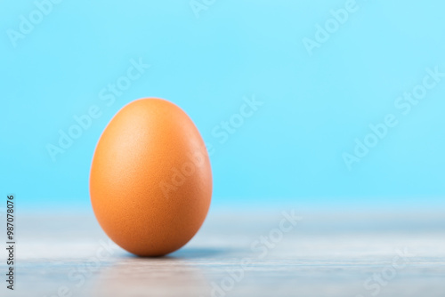 Wallpaper Mural Single fresh egg rests on a table against a light blue, symbolizing nature nutrition and wholesome food choices. Emphasizes the simplicity and purity of basic ingredients in a balanced diet Torontodigital.ca