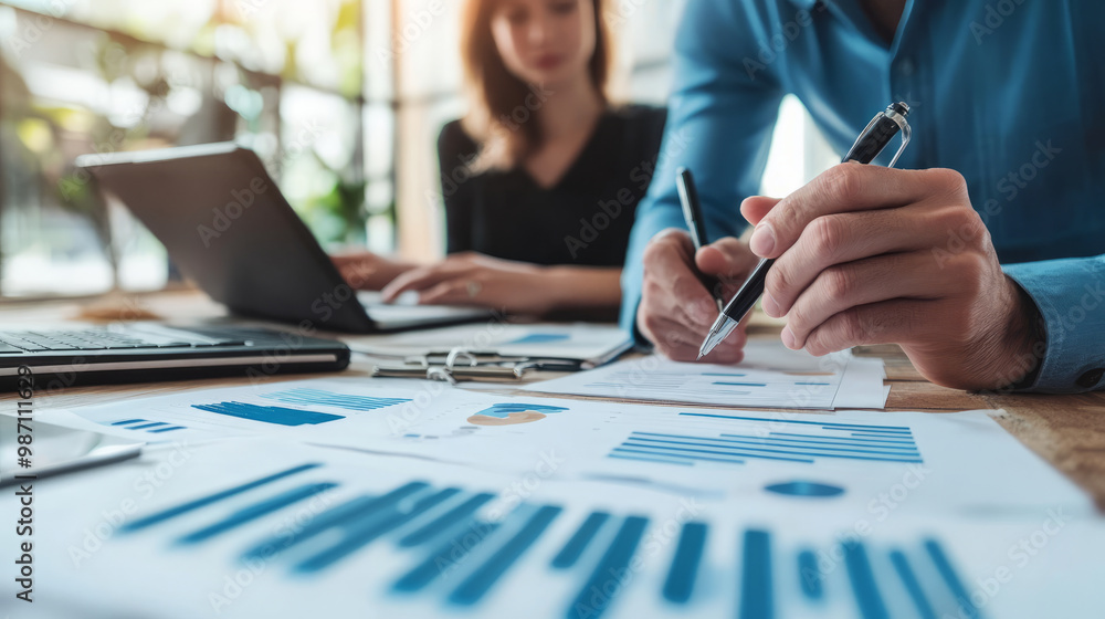A leader consulting with data analysts to determine the best decision based on predictive models A leader consulting with data analysts to determine the best decision based on predictive models