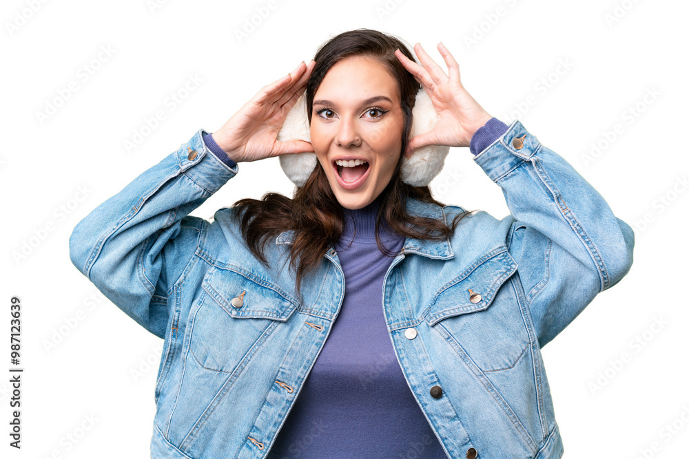Young caucasian woman wearing winter muffs over isolated background with surprise expression Young caucasian woman wearing winter muffs over isolated background with surprise expression