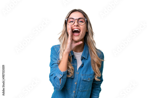 Young Uruguayan woman over isolated background shouting with mouth wide open