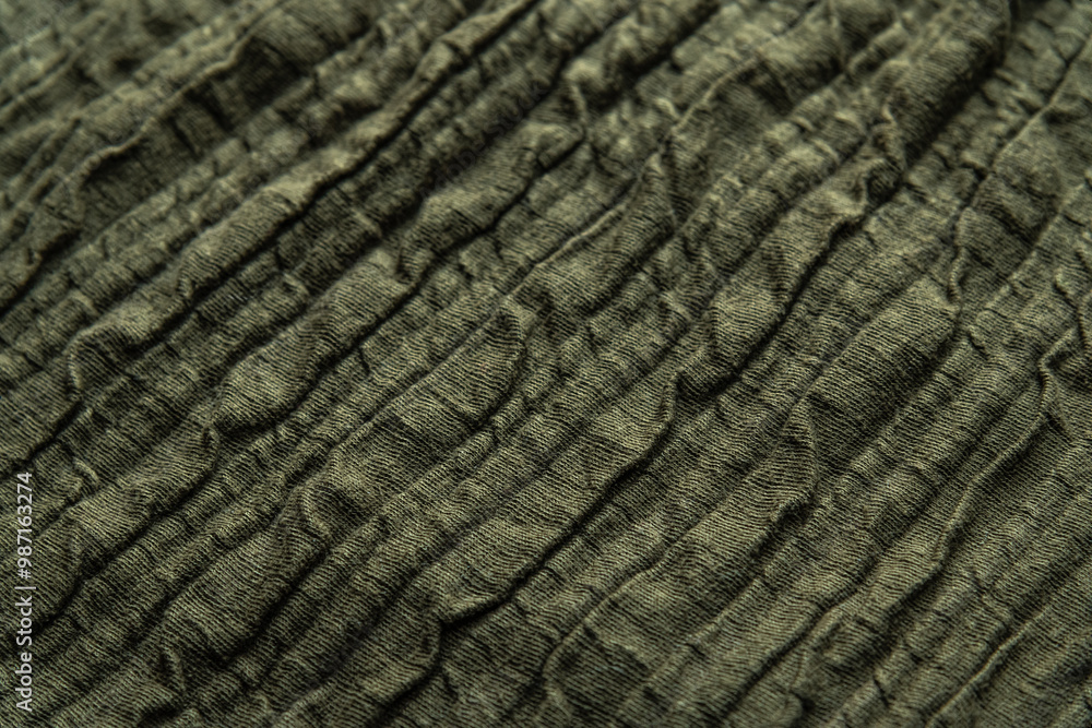 abstract background of an old green cotton voluminous knit fabric close up shallow depth of field abstract background of an old green cotton voluminous knit fabric close up shallow depth of field