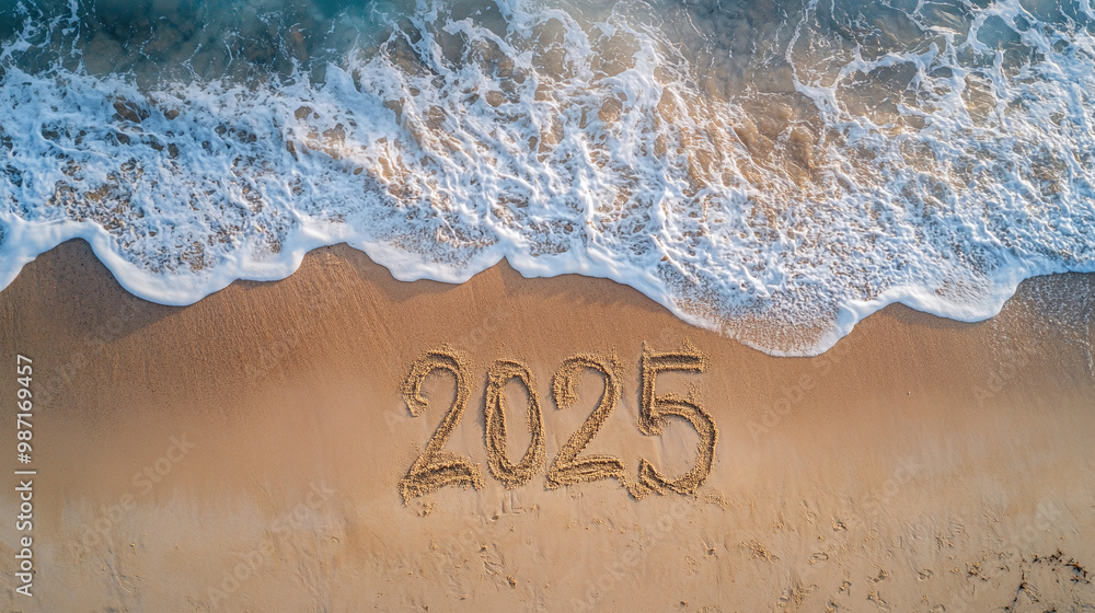 Fototapeta premium 2025 written on empty beach near sea wave symbolizing arrival of new year 2025