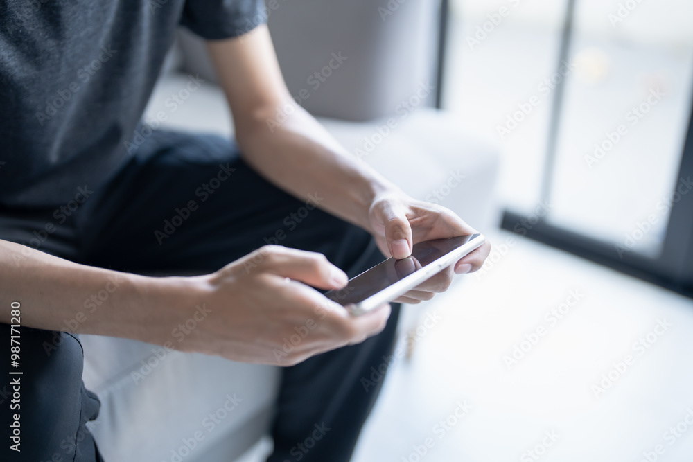 Man playing game on mobile phone. gamer boy playing video games holding Smartphone working mobile devices. cell telephone technology e-commerce concept Man playing game on mobile phone. gamer boy playing video games holding Smartphone working mobile devices. cell telephone technology e-commerce concept