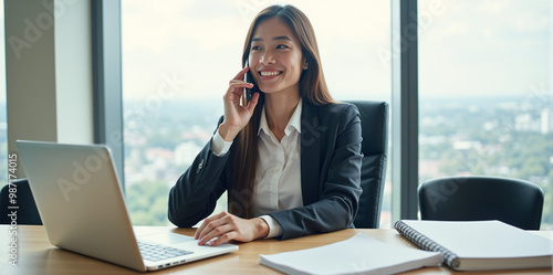 A  business woman is discussing a new strategy over the phone in a bright and productive office (with copy space).
