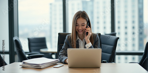 A  business woman is discussing a new strategy over the phone in a bright and productive office (with copy space). photo