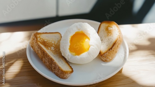 Huevo cocido en forma de nube, con una yema cremosa en el centro, acompañado de tostadas crujientes. photo