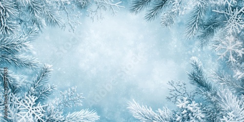 Snow-laden branches frame a serene winter landscape illuminated by the soft blue light of dawn