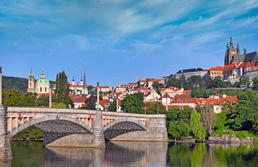 View from the bank of the Vltava river to Manes bridge and the Prague castle, Czech republic View from the bank of the Vltava river to Manes bridge and the Prague castle, Czech republic