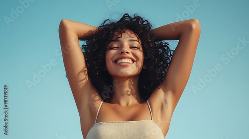 Beautiful young happy African-American body positive woman in tight jeans on blue background photo