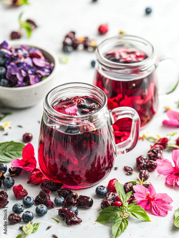 Refreshing hibiscus drink with flowers and berries Refreshing hibiscus drink with flowers and berries