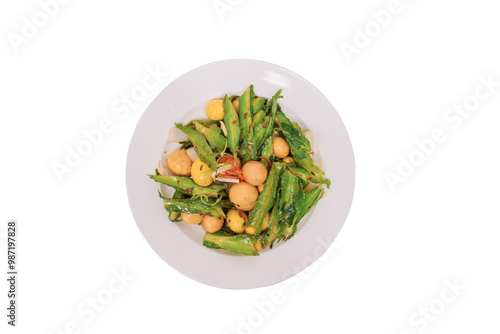 A plate of stir-fried eggs with winged beans, showcasing vibrant green pods and yellow egg pieces, offering a visual representation of a nutritious meal.