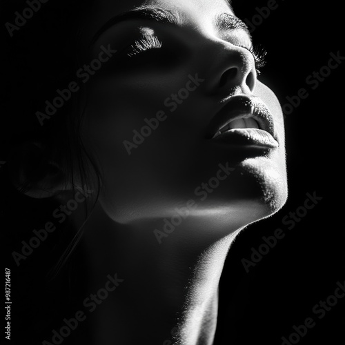 Dramatic black and white portrait of a beautiful woman on a dark background