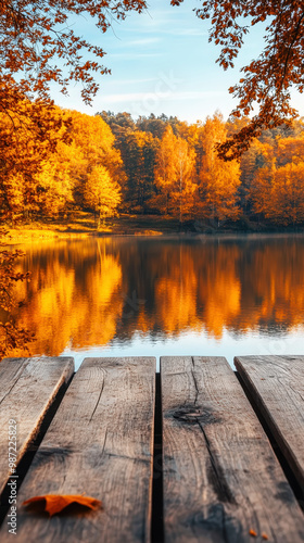 Aesthetic autumn lake surrounded by vibrant fall trees, wooden table for product placement. Generative AI