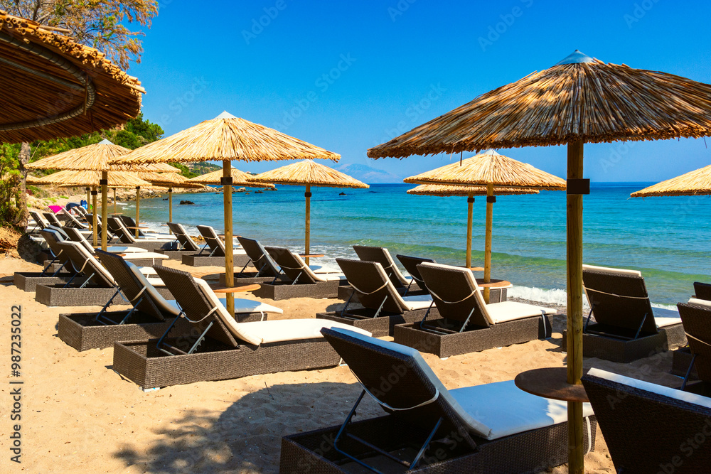 Summer beach scene with sunbathers and umbrellas