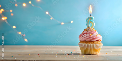 Birthday cupcake with burning candle displaying number 16 for sixteenth anniversary celebration, birthday, cupcake, candle photo