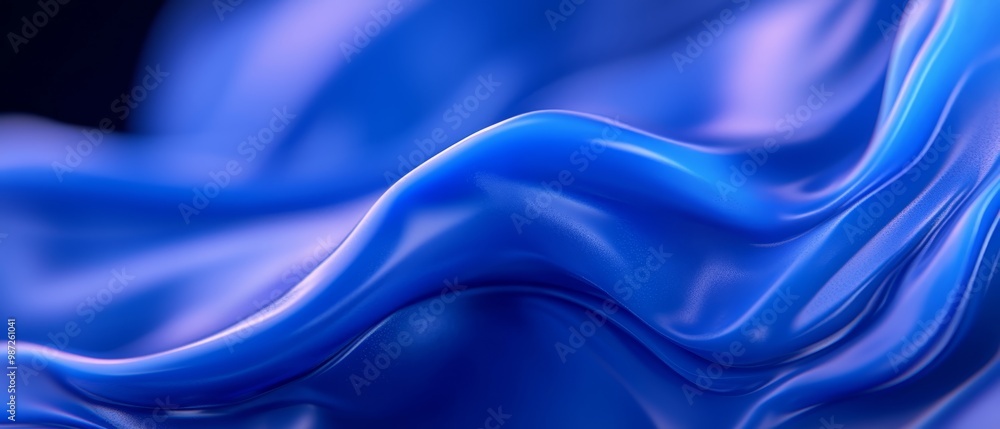 A tight shot of a blue fabric, featuring a wavy pattern at its bottom edge against a black backdrop A tight shot of a blue fabric, featuring a wavy pattern at its bottom edge against a black backdrop