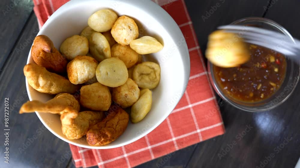 a bowl of kikiam, fish ball and squid ball with sweet chili soy sauce a bowl of kikiam, fish ball and squid ball with sweet chili soy sauce