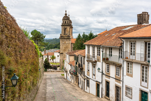 Picturesque street with old buildings and medieval church in the city of Santiago de Compostela, Galicia.