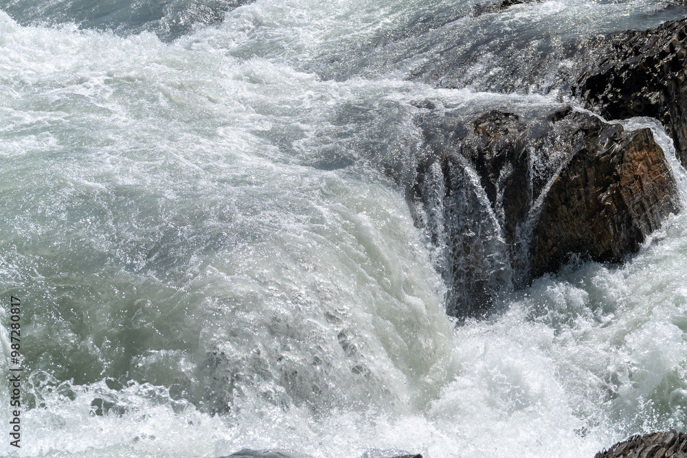Close up of a waterfall along a rocky river Close up of a waterfall along a rocky river