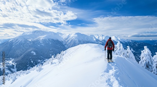 A man in ski gear walks on a snowy mountain top.