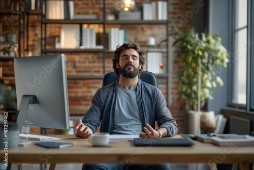 Finding Zen in the Chaos: Professional Meditating at Computer Amid High-Pressure Deadline, Demonstrating Stress Management photo