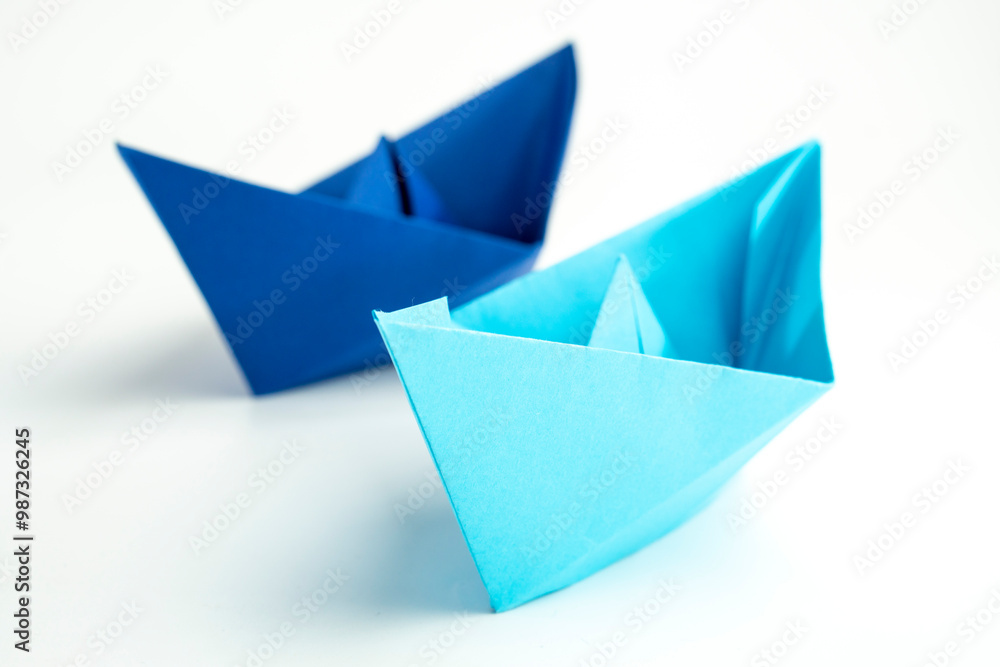 Paper colored boat isolated on white background with reflection. origami crafts. transport concept. origami Paper colored boat isolated on white background with reflection. origami crafts. transport concept. origami