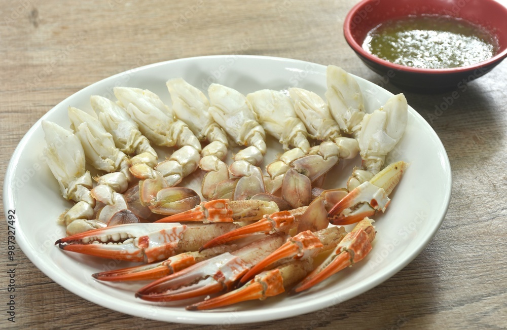 steamed flower crab meat paddle and claw on plate dipping Thai spicy seafood sauce steamed flower crab meat paddle and claw on plate dipping Thai spicy seafood sauce